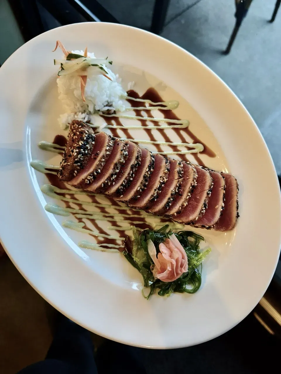 Sesame-crusted seared tuna with rice, greens, and sauces